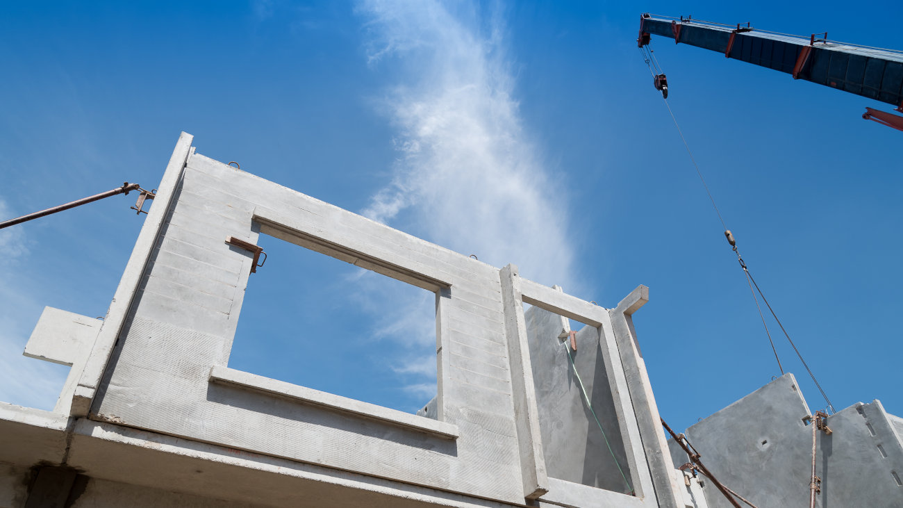 Crane installation of a prefabricated section of building.