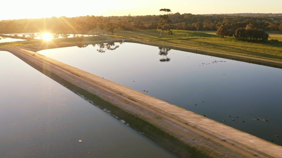 The sun reflecting off still water reservoirs.