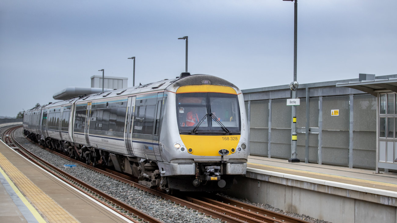 Train beside a station platform.