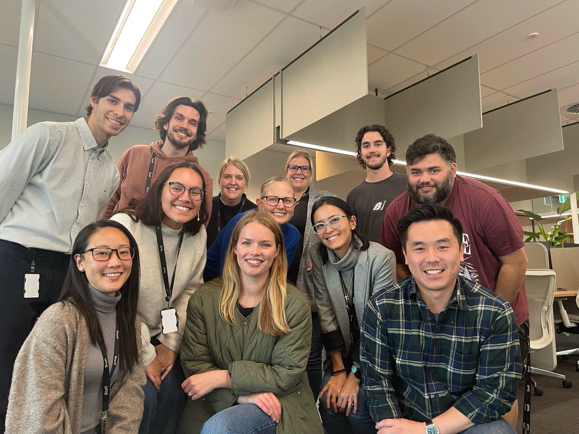 A group of workers posing in office space.