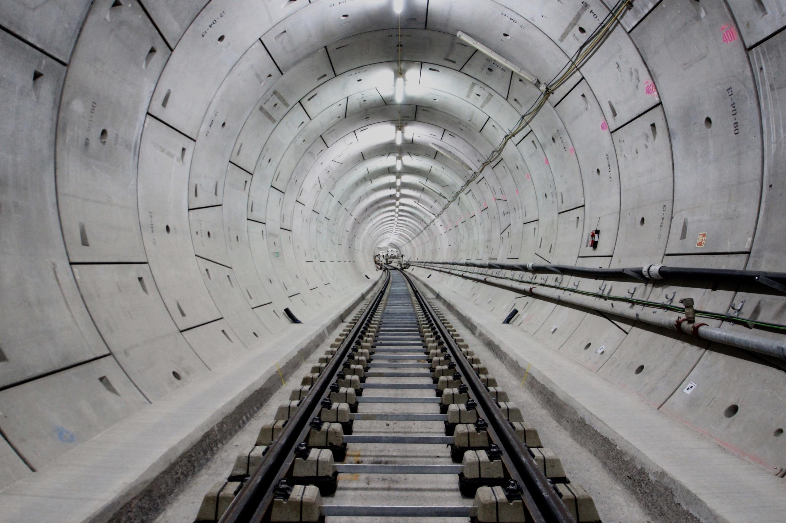 Railway tracks along a bright tunnel, Crossrail.