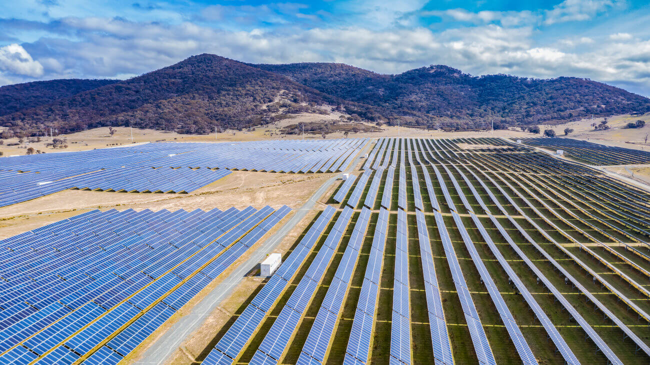 Solar farm with hills in the background.
