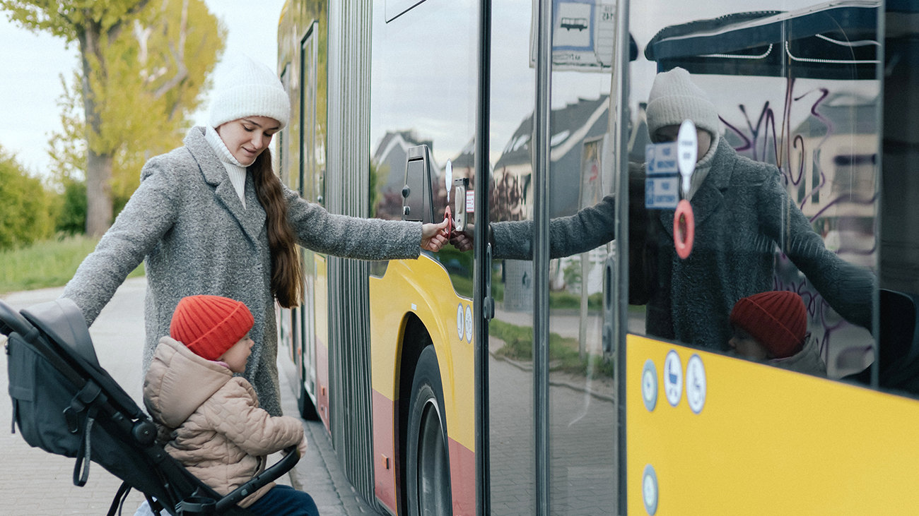Mother and child getting onto a bus.