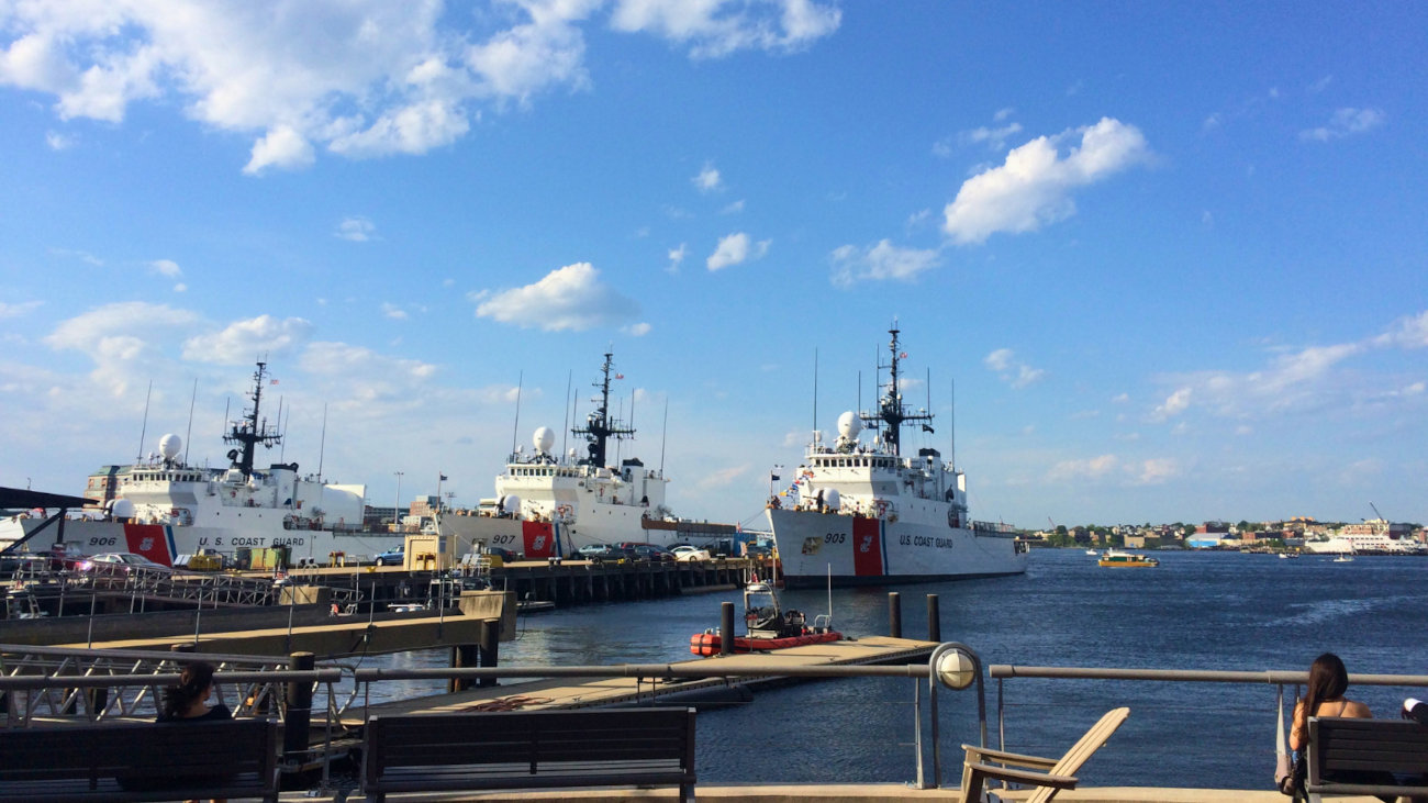 Three naval ships in port.