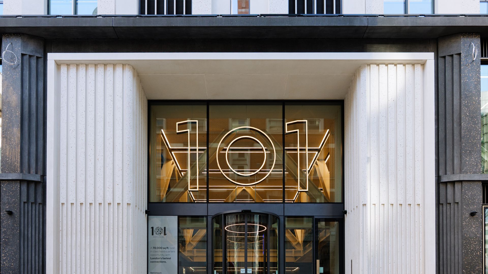 Entrance of 101 Moorgate featuring illuminated ‘101’ signage, showcasing the building’s modern engineering and architectural design.