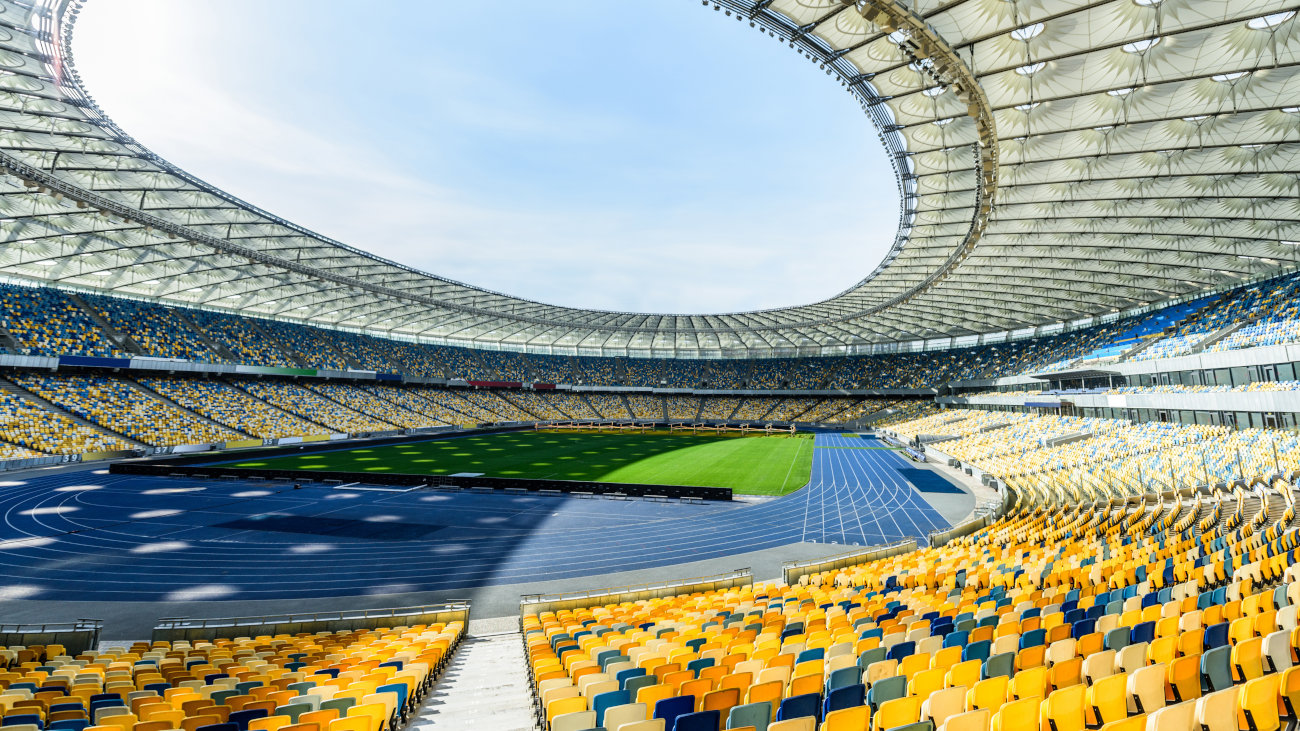 View across the interior of a sunlit stadium.