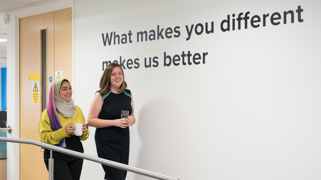 Mott MacDonald employees walking down a corridor.