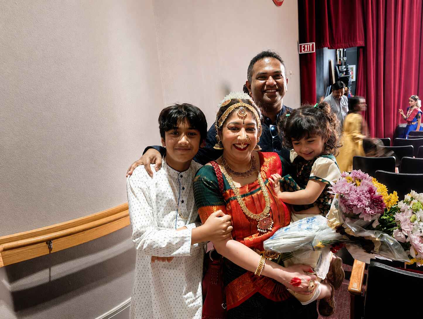 Woman standing with her family hugging and smiling