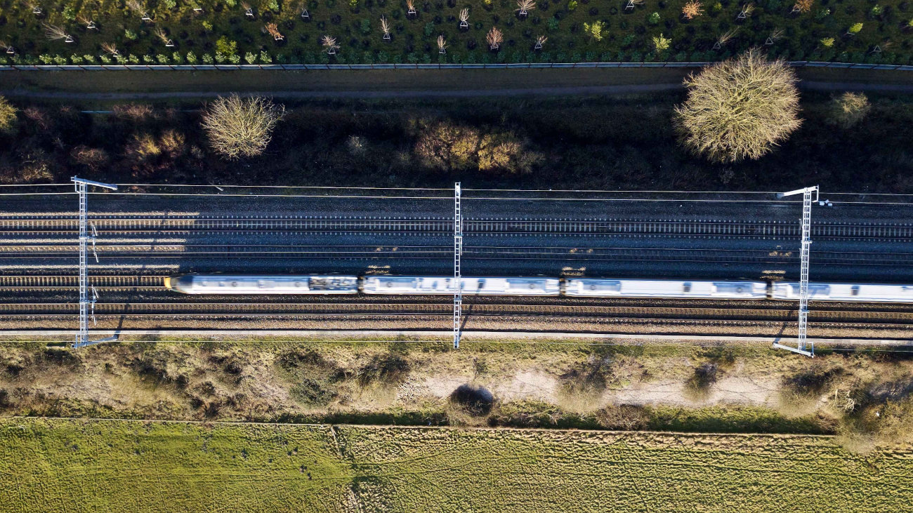 Overhead shot of train moving along railway tracks.