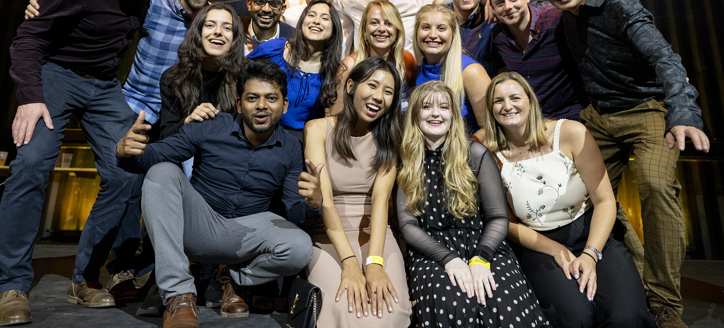 A group of smiling co-workers pose for a photo.