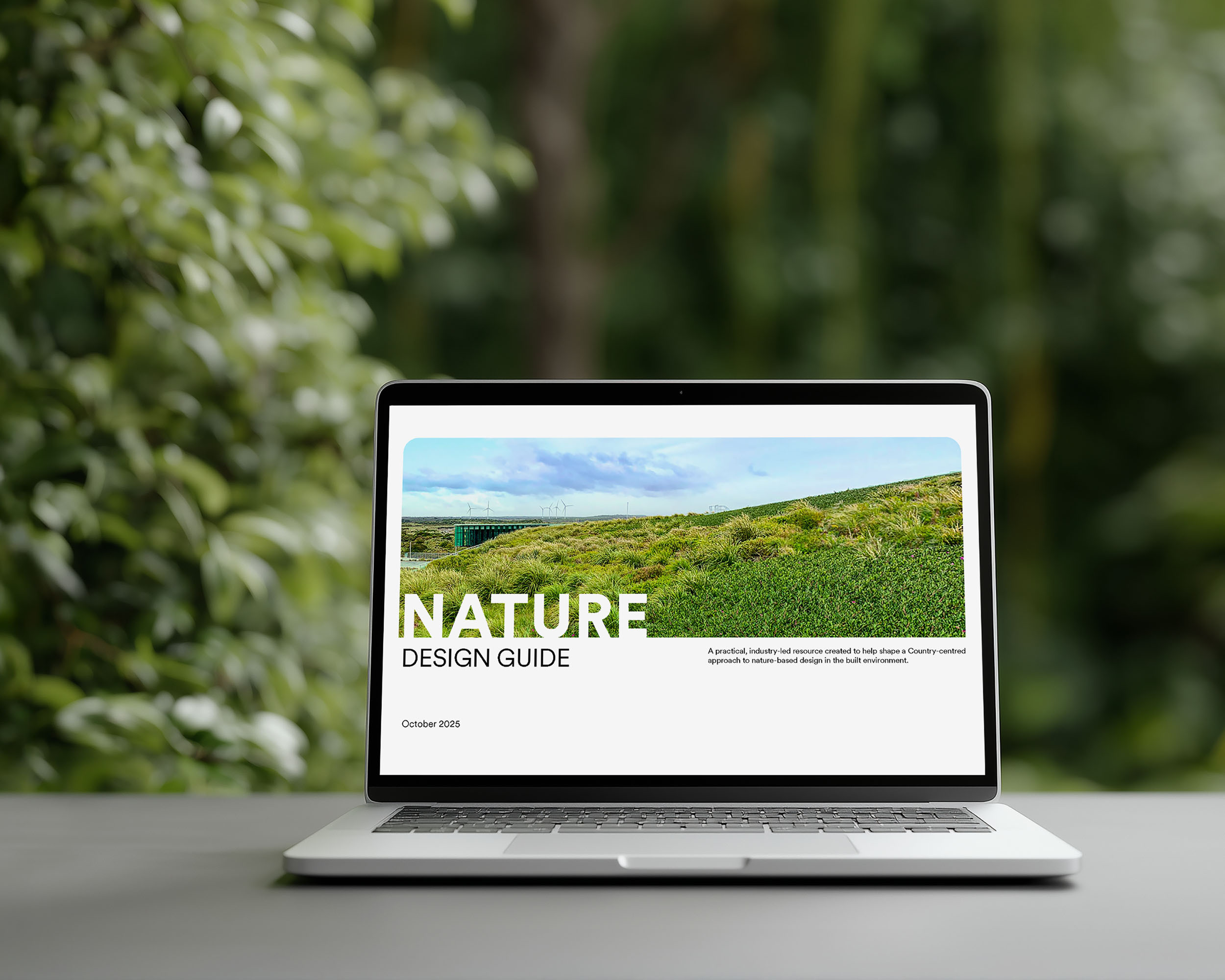 The Nature Design Guide on a laptop.