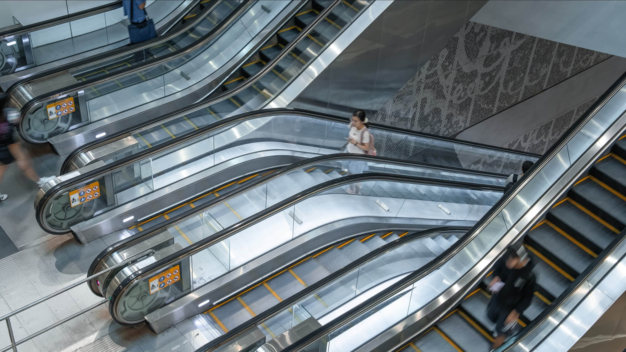 People using escalators.