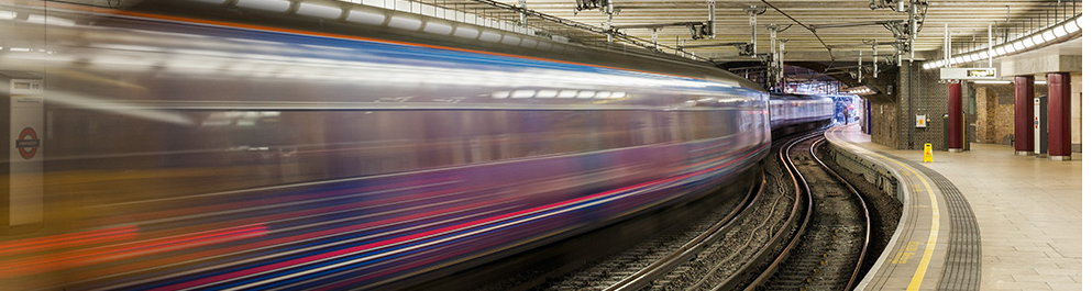 Long exposure shot of a train passing a London Underground station.
