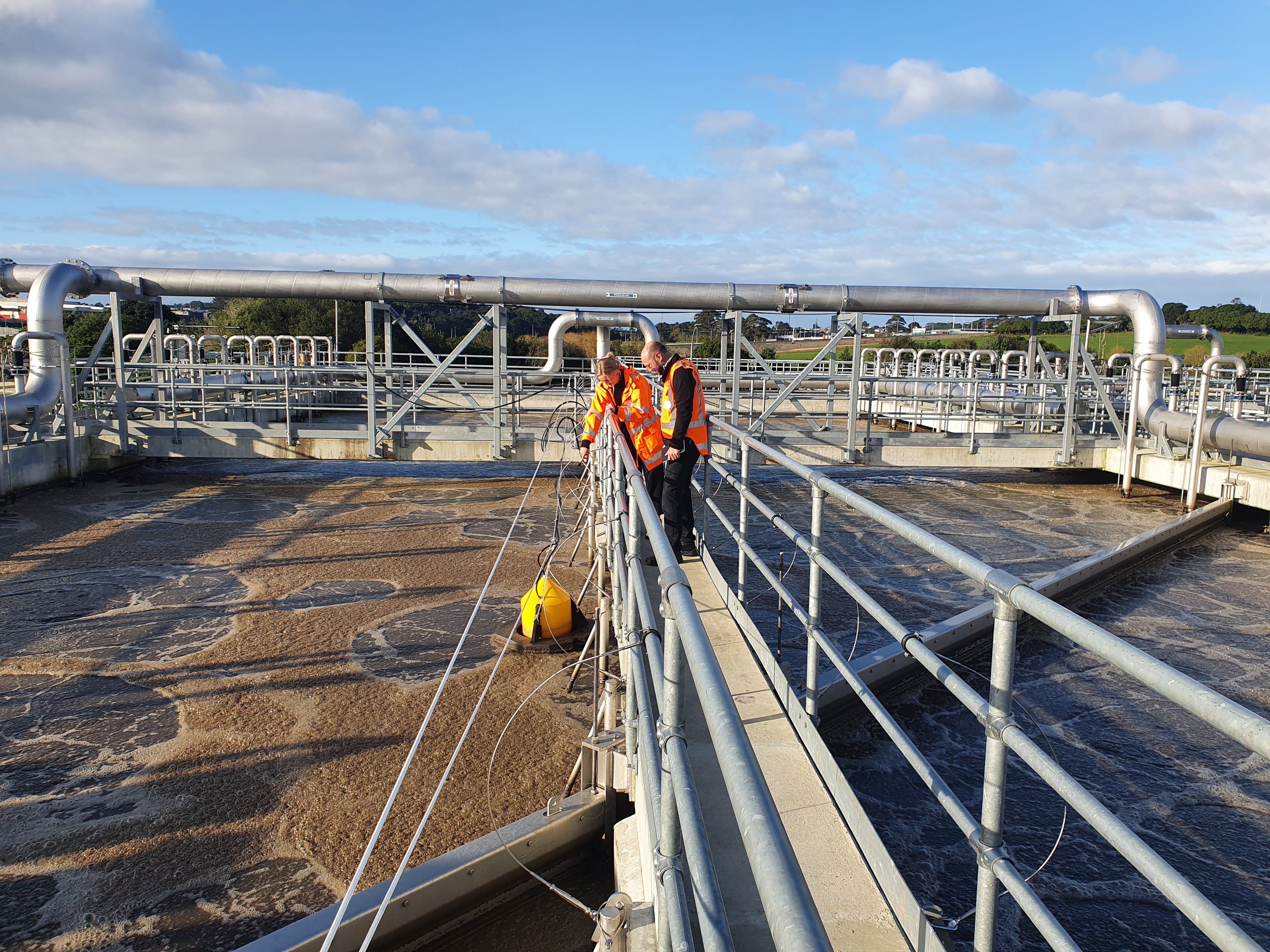 Construction site with workers looking over scaffolding. 
