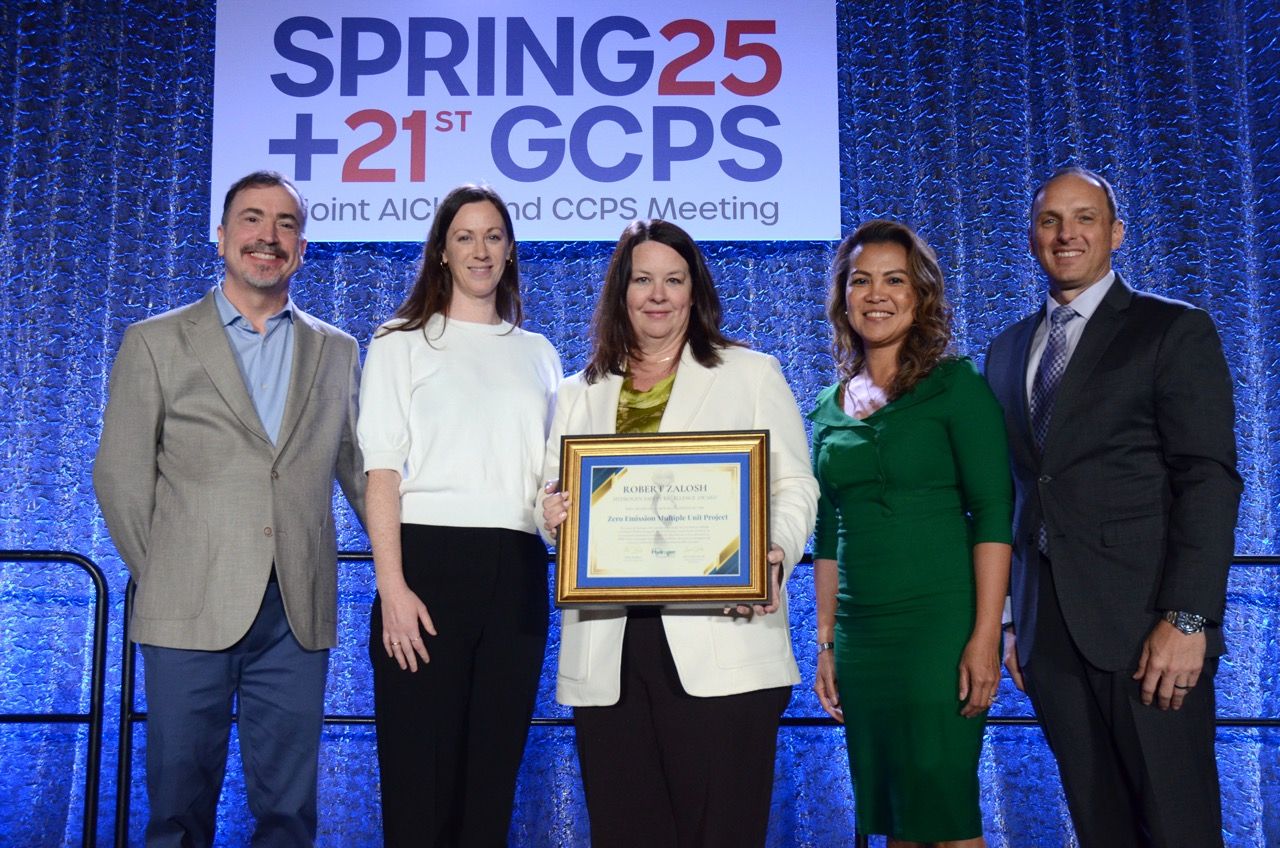 People standing with an award.