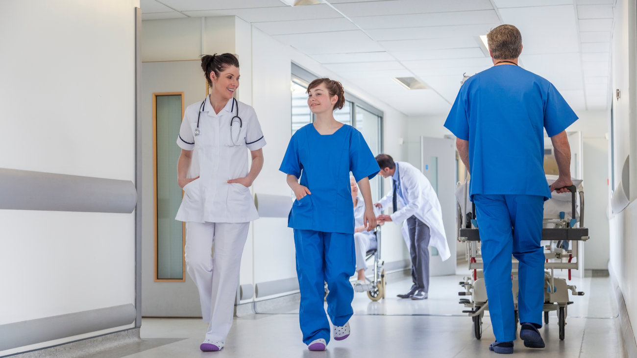 Doctors and nurses walking down a hospital corridor.