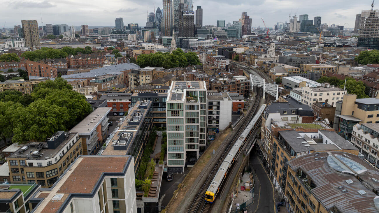 Train moving through London with the City in the background.