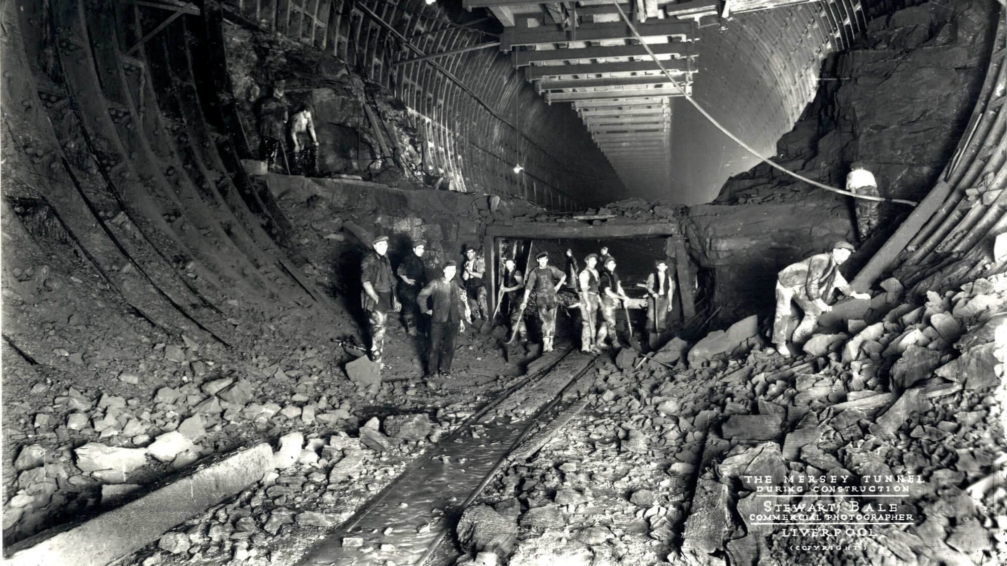 Black and white image of workers during construction of the Queensway Tunnel under the Mersey.