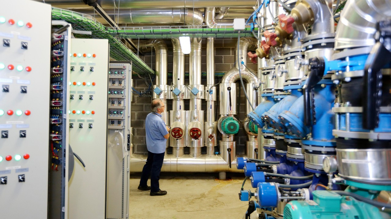 Man working in a hospital laboratory, representing healthcare innovation and climate resilience.