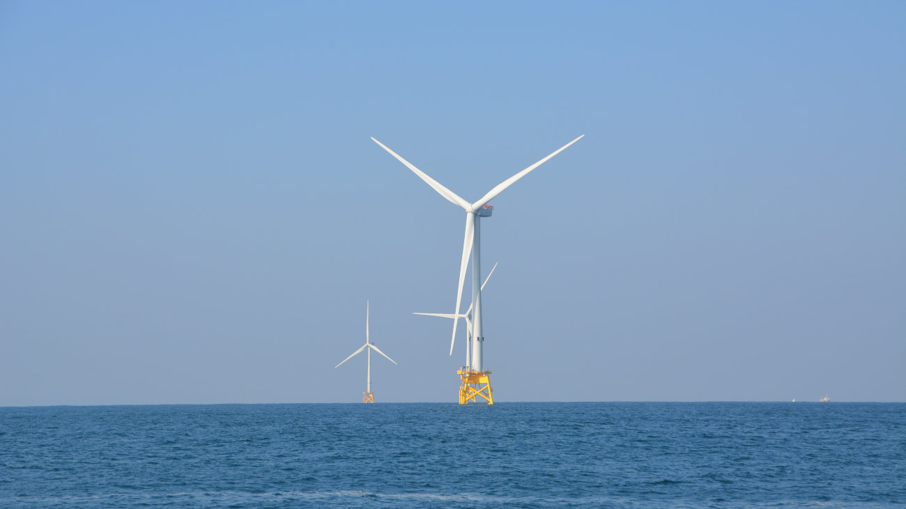 Offshore wind turbines surrounded by ocean.
