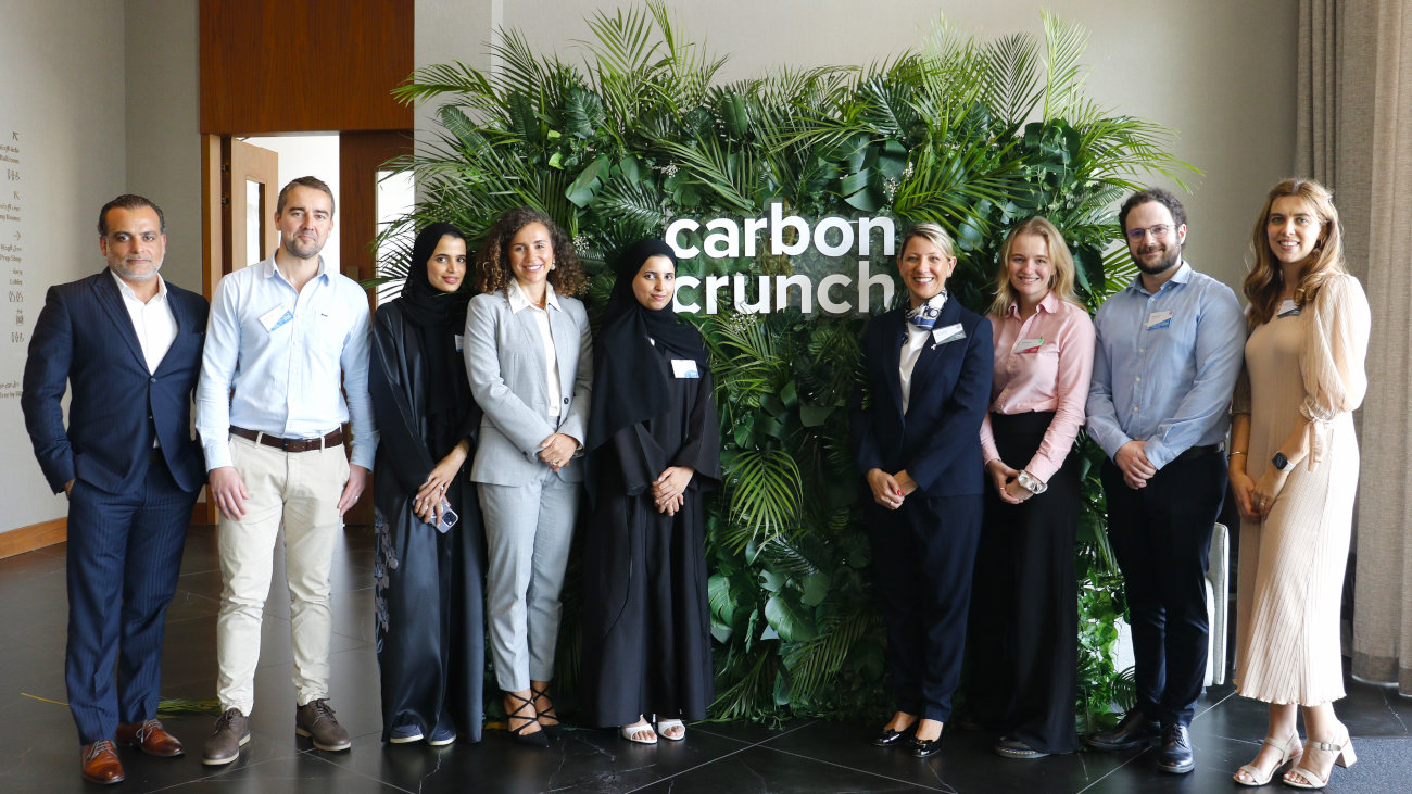 Group of people in front of a Carbon Crunch sign.