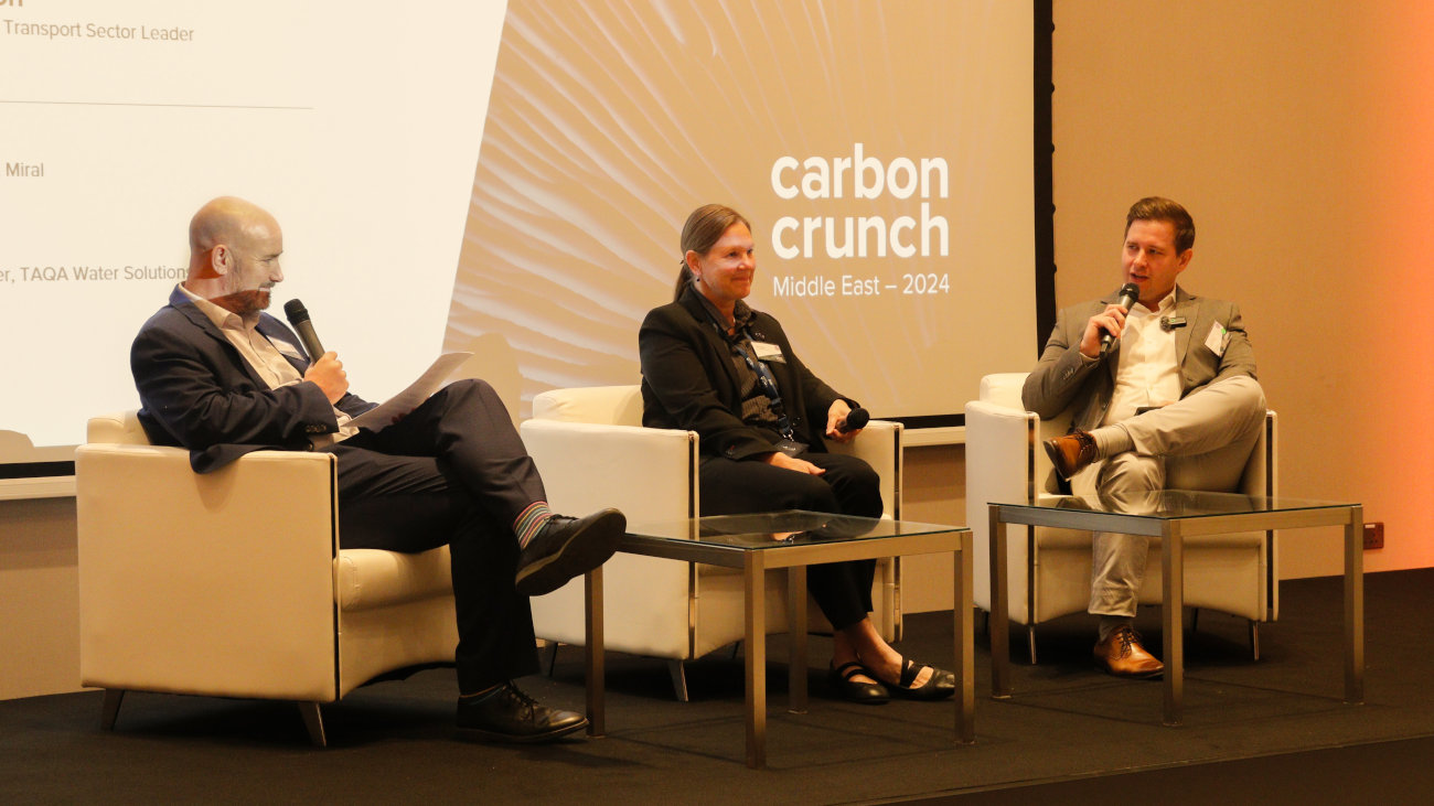 Three people on stage during a Carbon Crunch panel discussion.