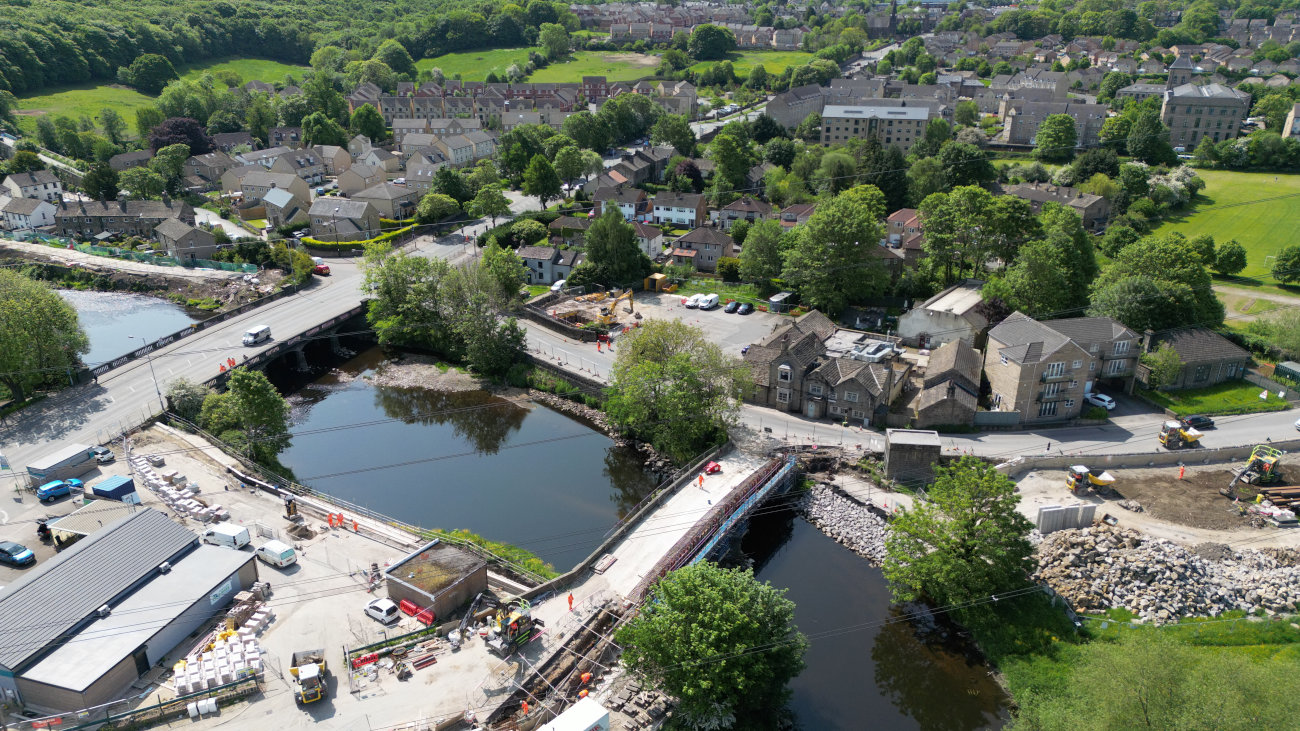 Bridge construction over a river on the edge of a town.