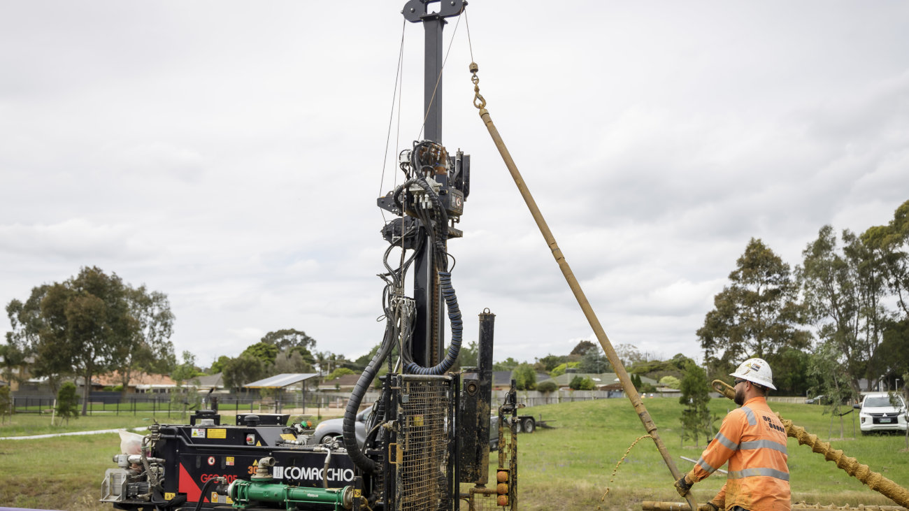 Engineer in hi-vis jacket operating machinery.