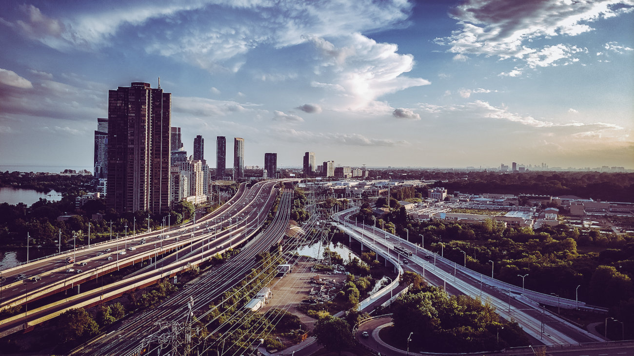 Wide shot of motorways, rail lines, and other transport infrastructure heading into Toronto.