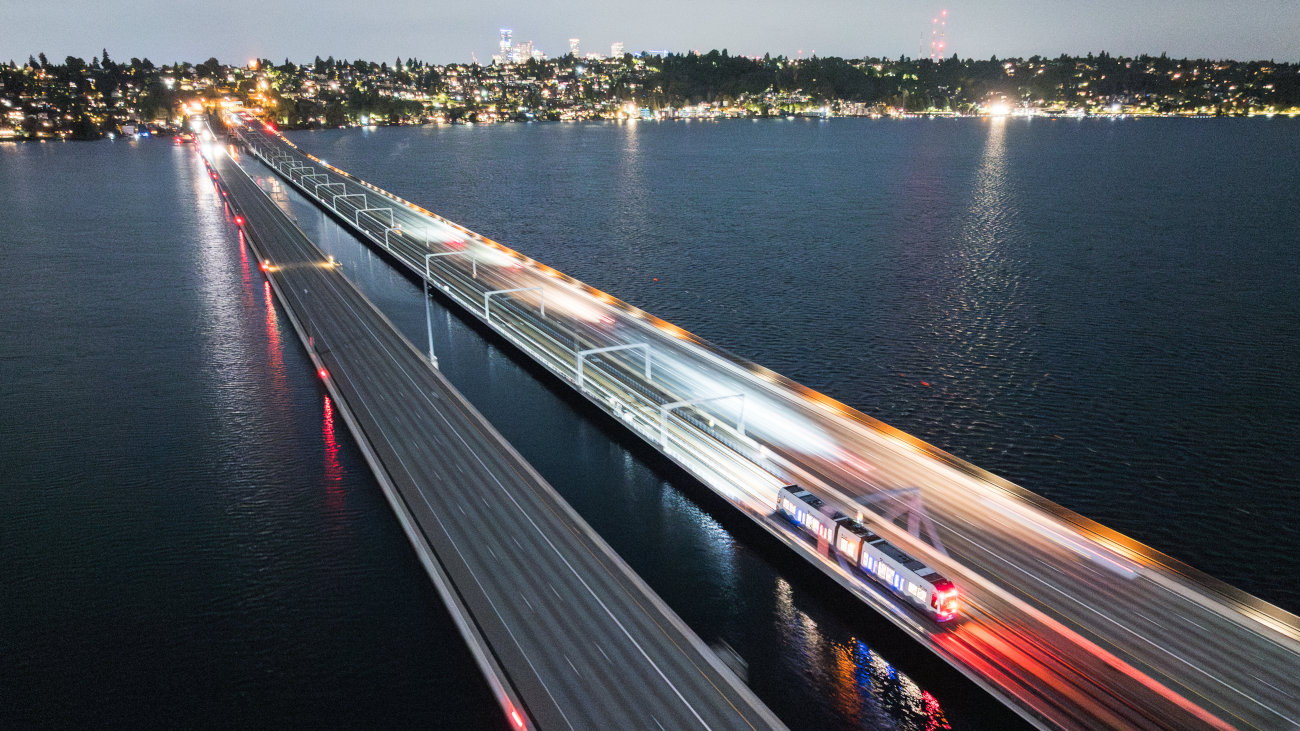 A light rail vehicle crosses floating bridge during the first night of Crosslake livewire testing on September 8, 2025.