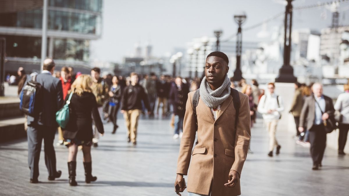 Man walking on London Thames sidewalk