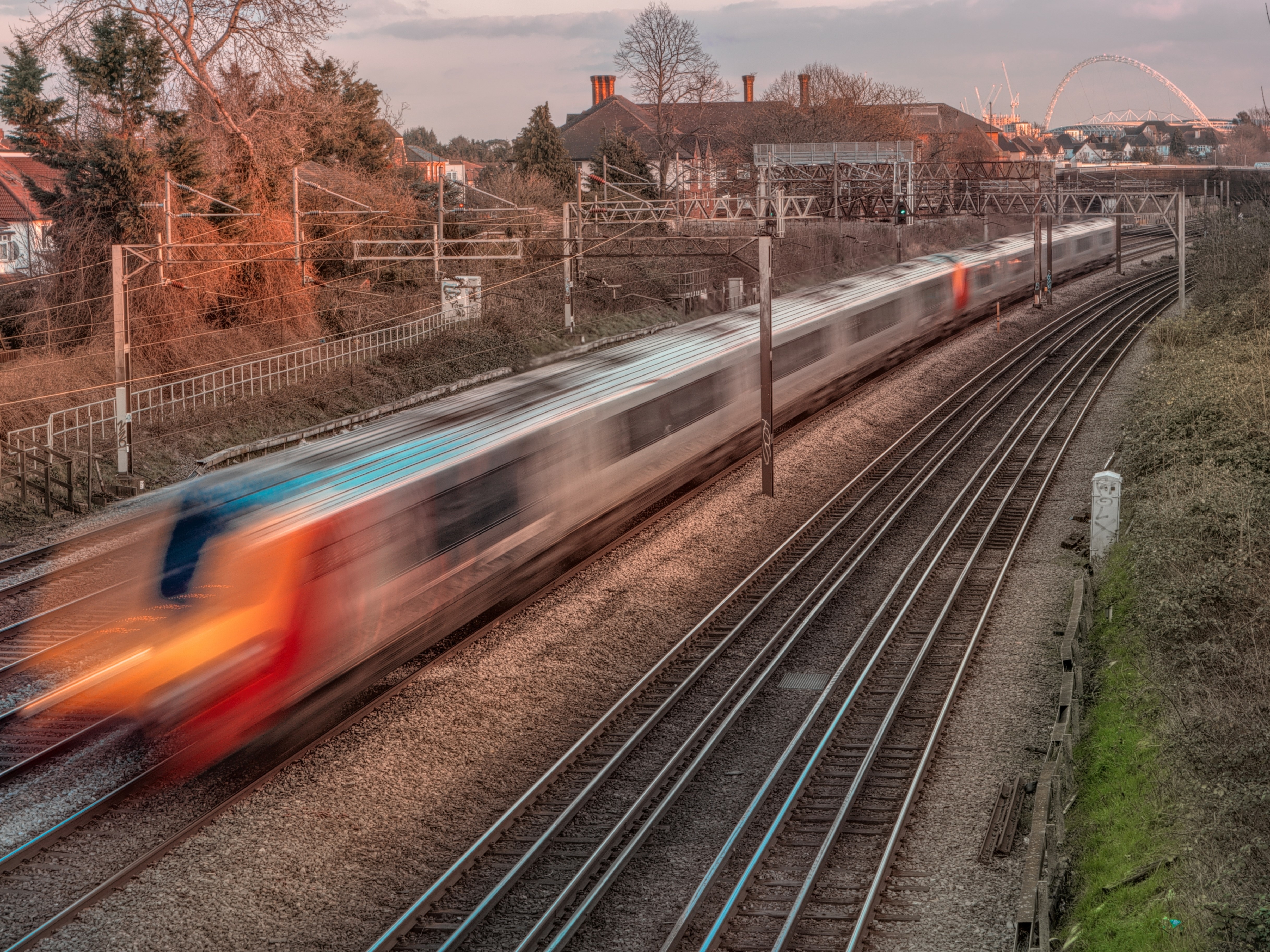 A commuter train traveling at a rapid pace.